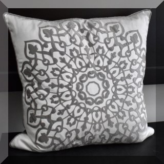 D47. White pillow with gray medallion decoration.
